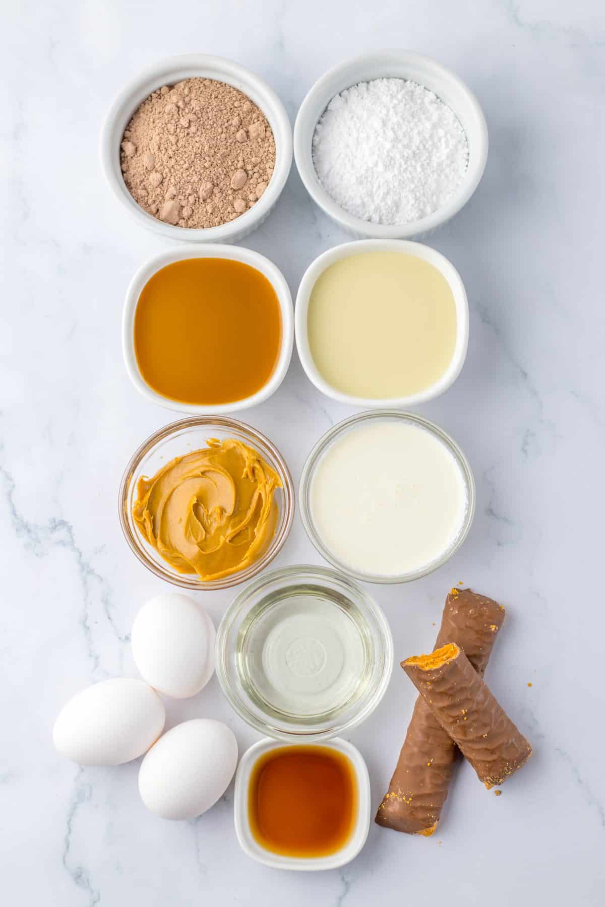an overhead image showing the measured ingredients needed to make a butterfinger poke cake