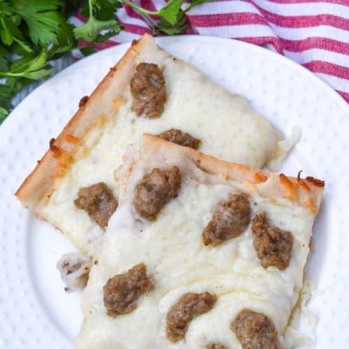 two slices of school breakfast pizza on a white plate