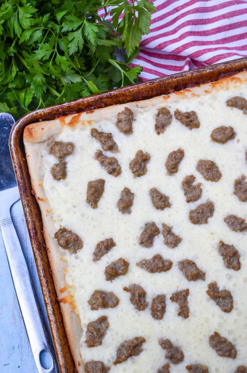 school breakfast pizza on a metal baking sheet