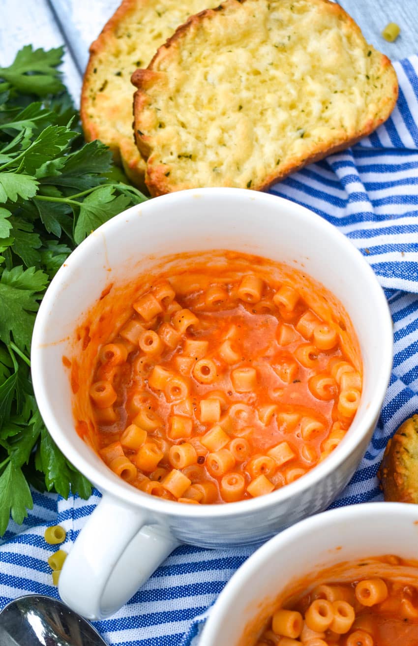 homemade microwave spaghettio's in two large white mugs