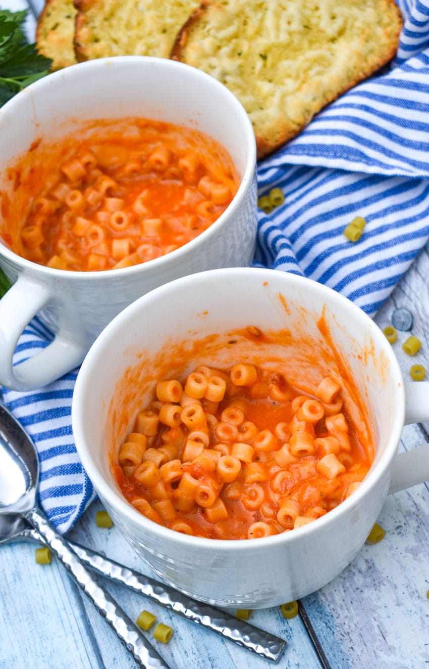 homemade microwave spaghettio's in two large white mugs