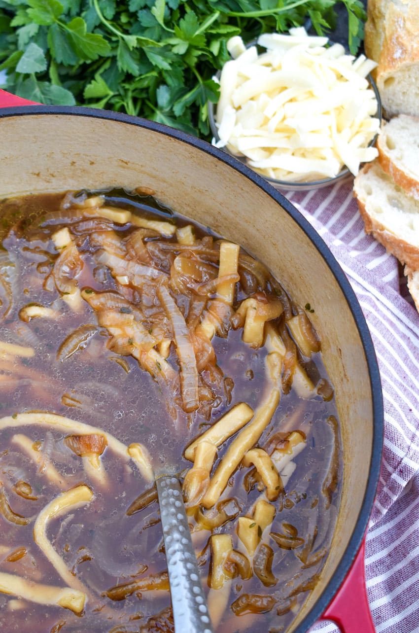 french onion chicken soup in a large cast iron dutch oven
