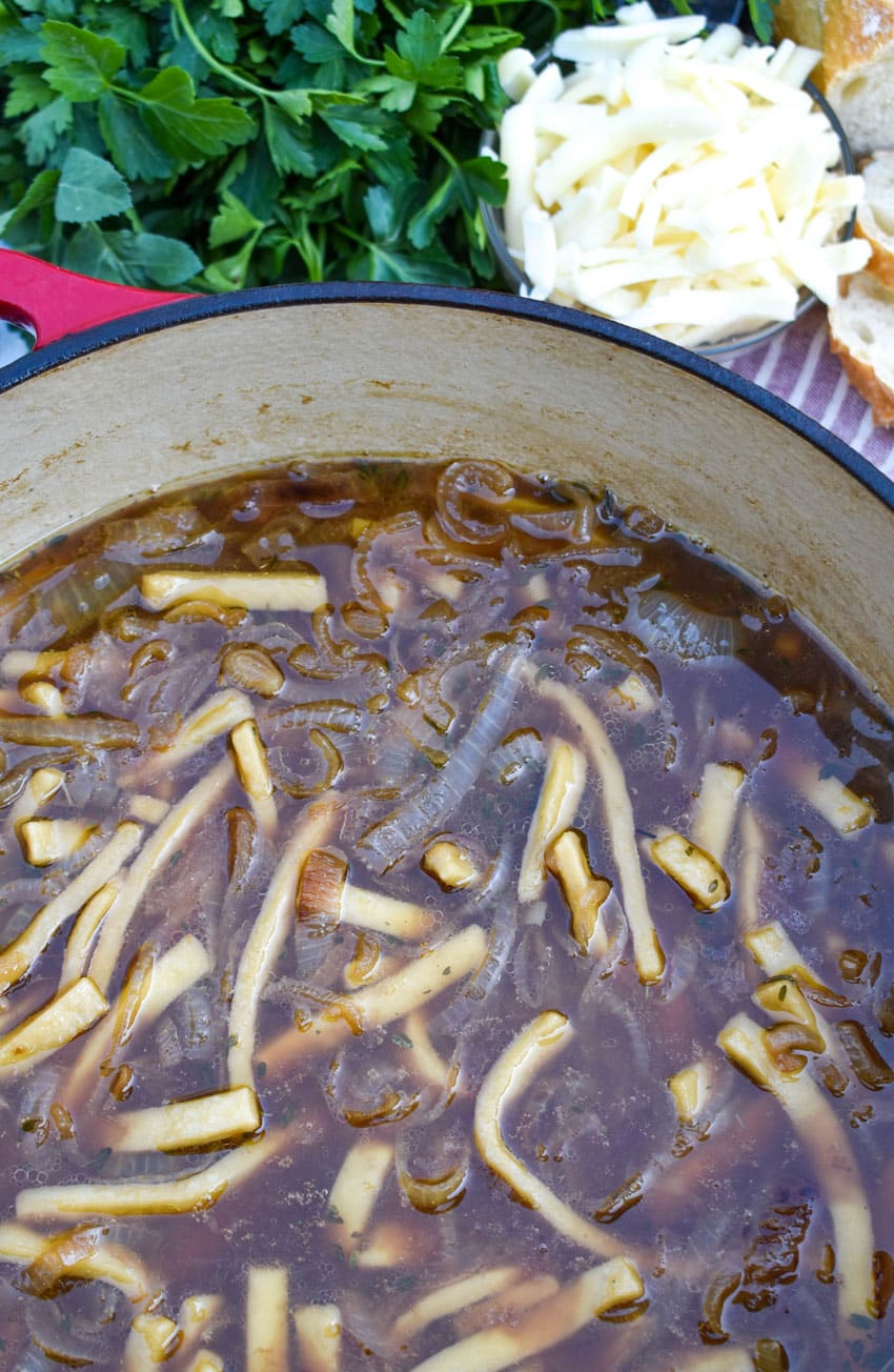 french onion chicken soup in a large cast iron dutch oven