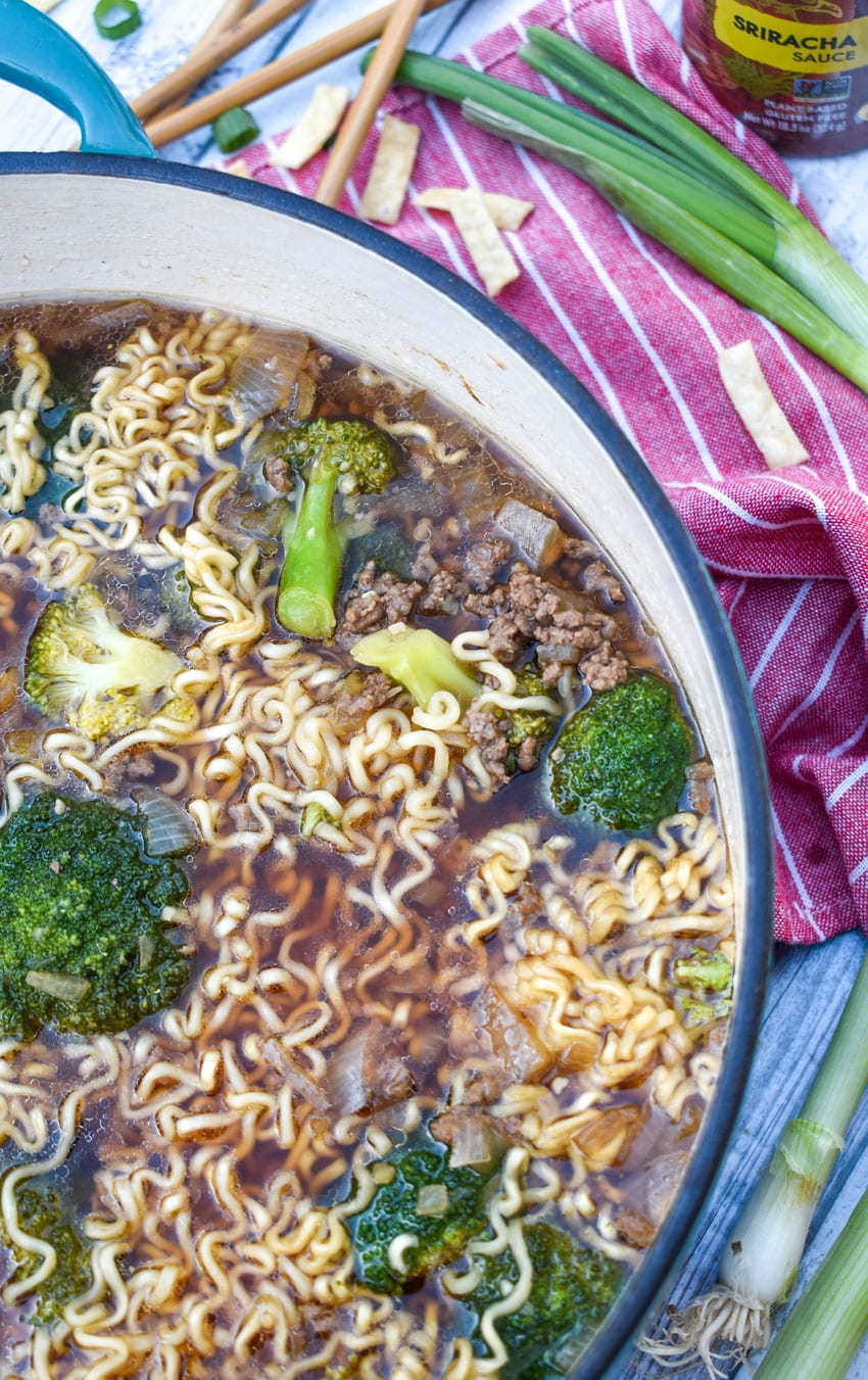 ground beef and broccoli ramen soup in a large cast iron pot