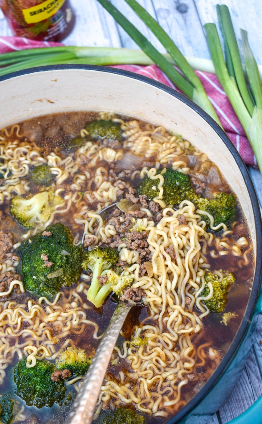 ground beef and broccoli ramen soup in a large cast iron pot