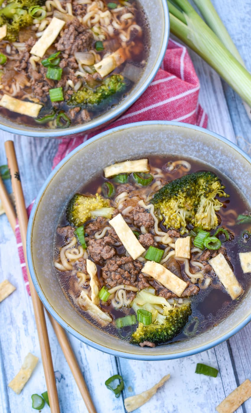ground beef and broccoli ramen soup in two small gray bowls