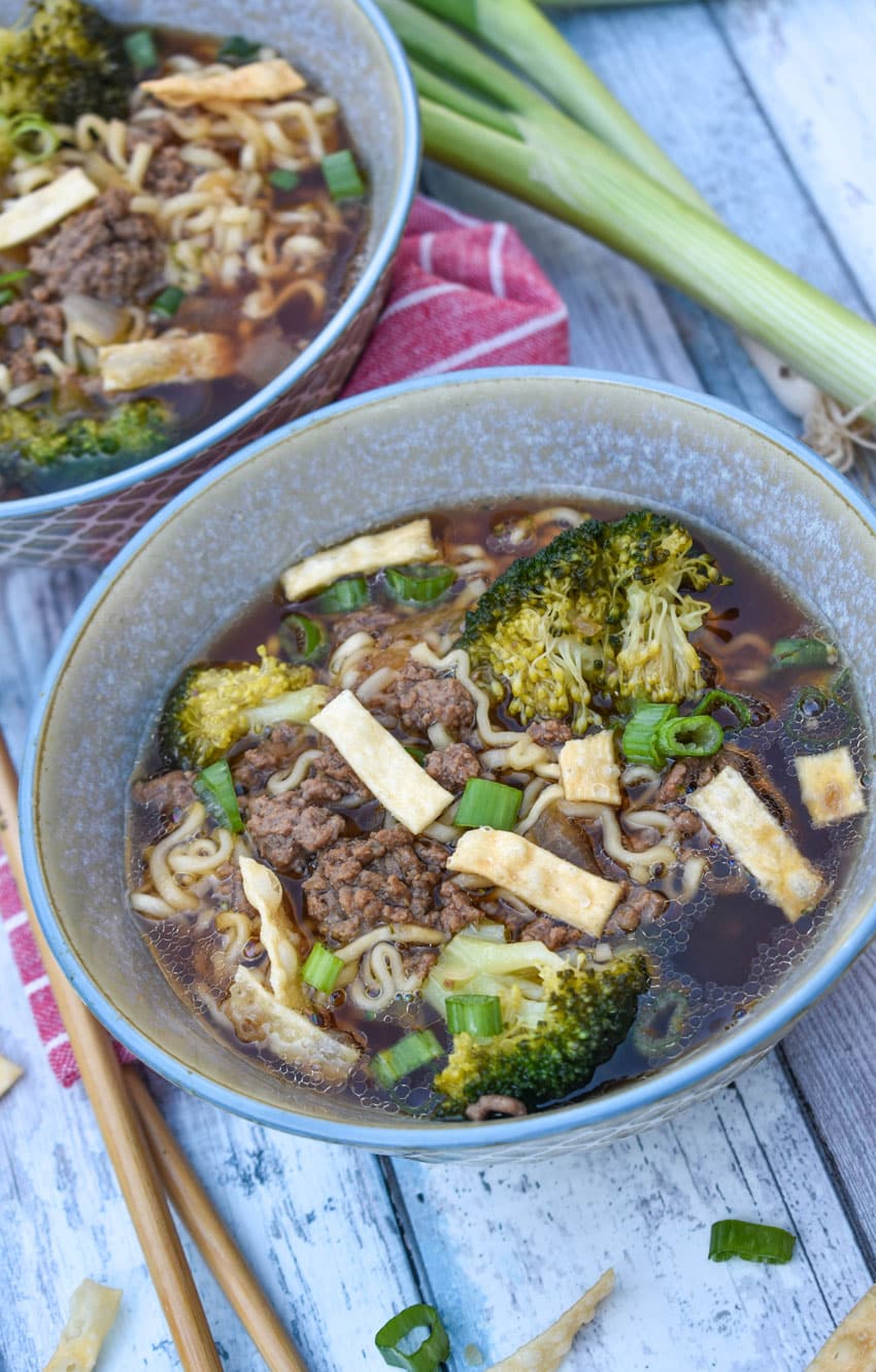 ground beef and broccoli ramen soup in two small gray bowls
