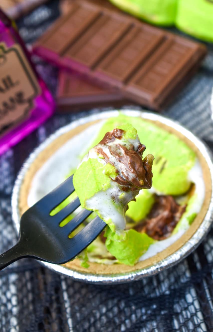 a black fork holding up a scoop of a halloween mini s'mores pie