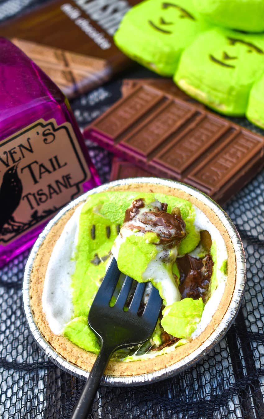 a black fork digging into a halloween peeps mini s'mores pie