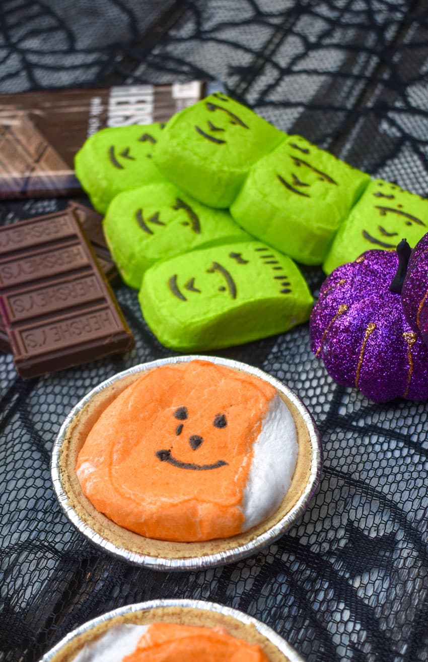 halloween mini s'more pie with hershey bars and green peeps in the background