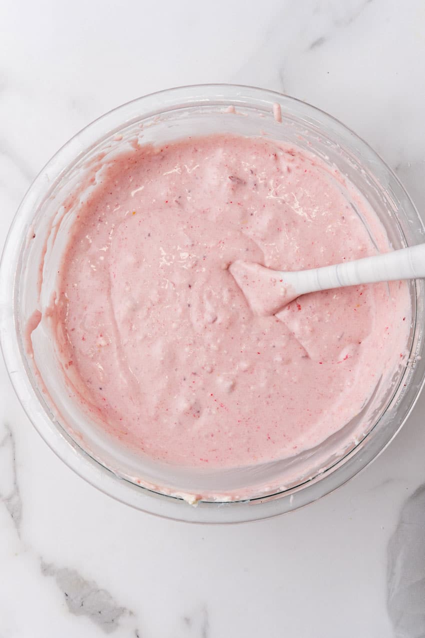 cranberry fluff pie filling in a glass mixing bowl