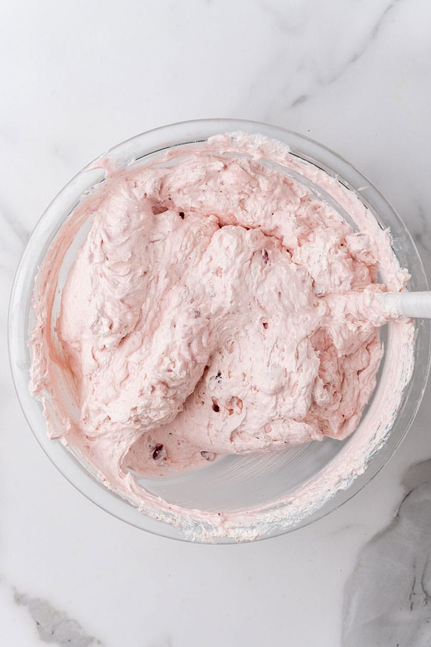 cranberry fluff pie filling in a glass mixing bowl