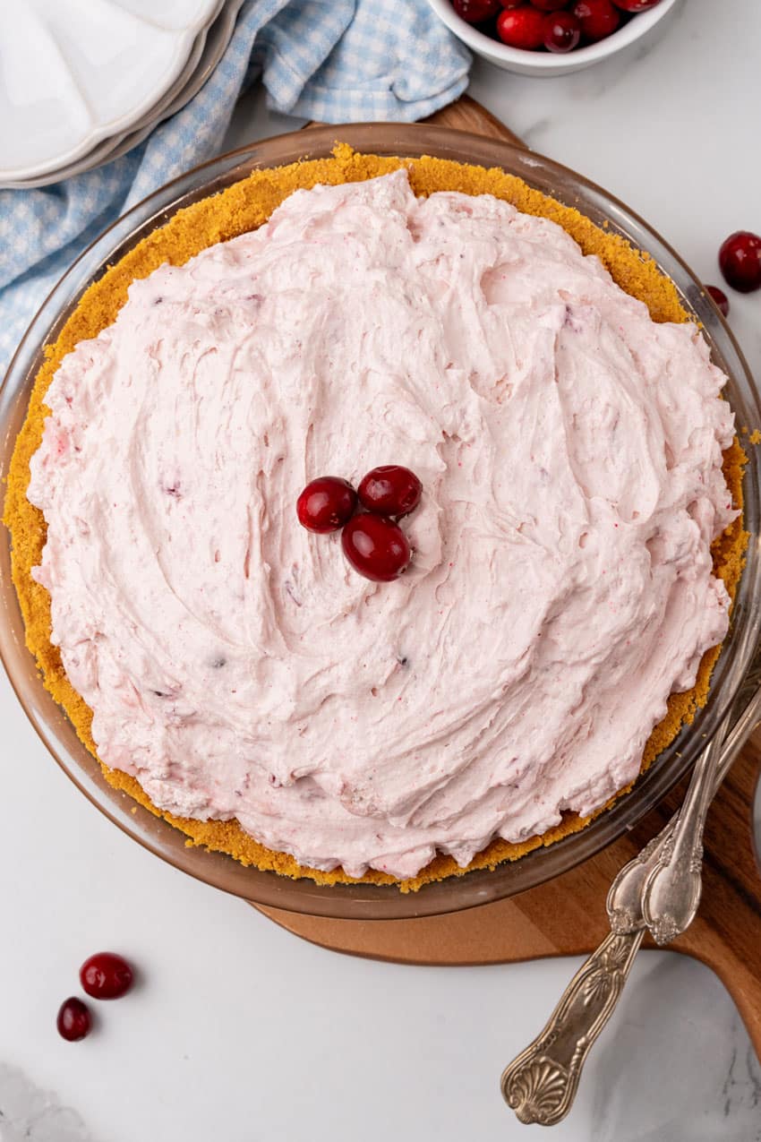 cranberry fluff pie on a wooden cutting board