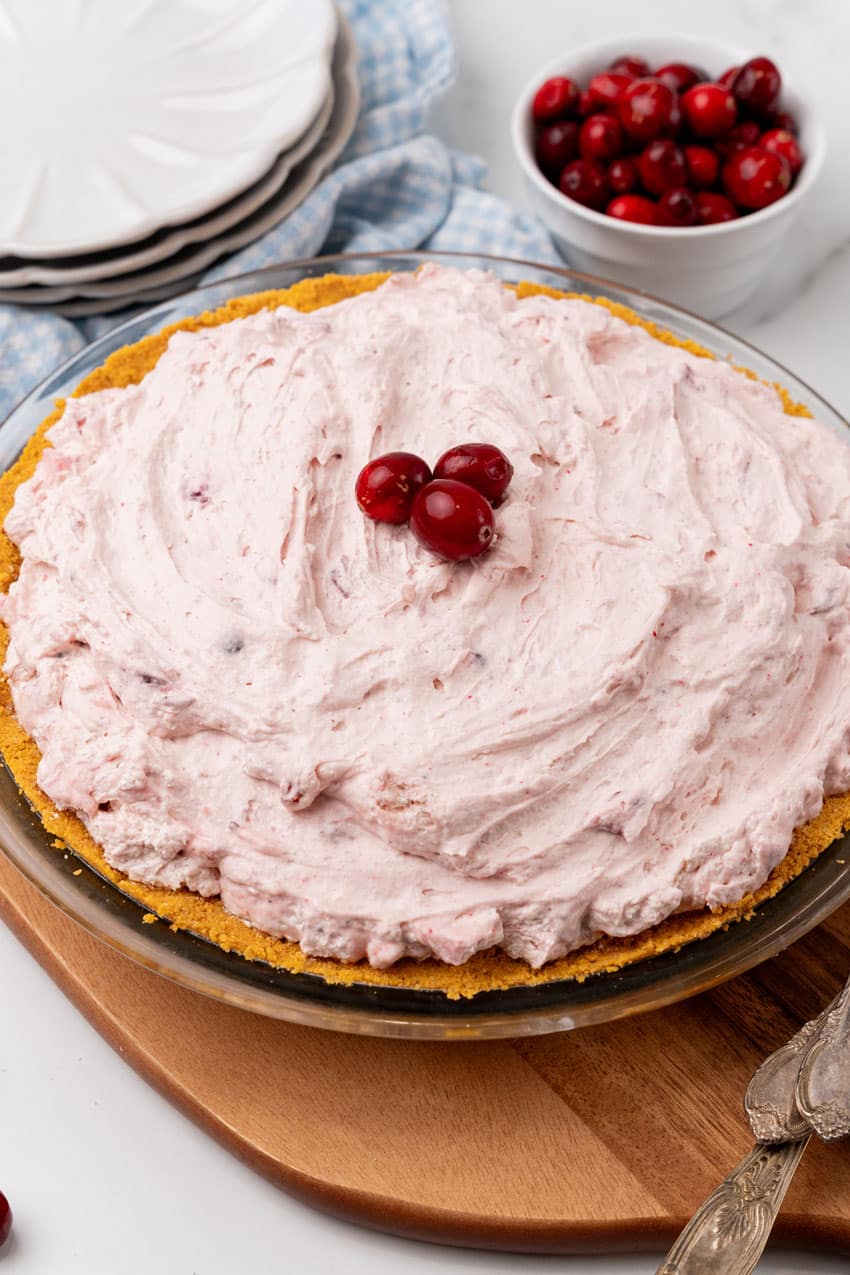 cranberry fluff pie on a wooden cutting board