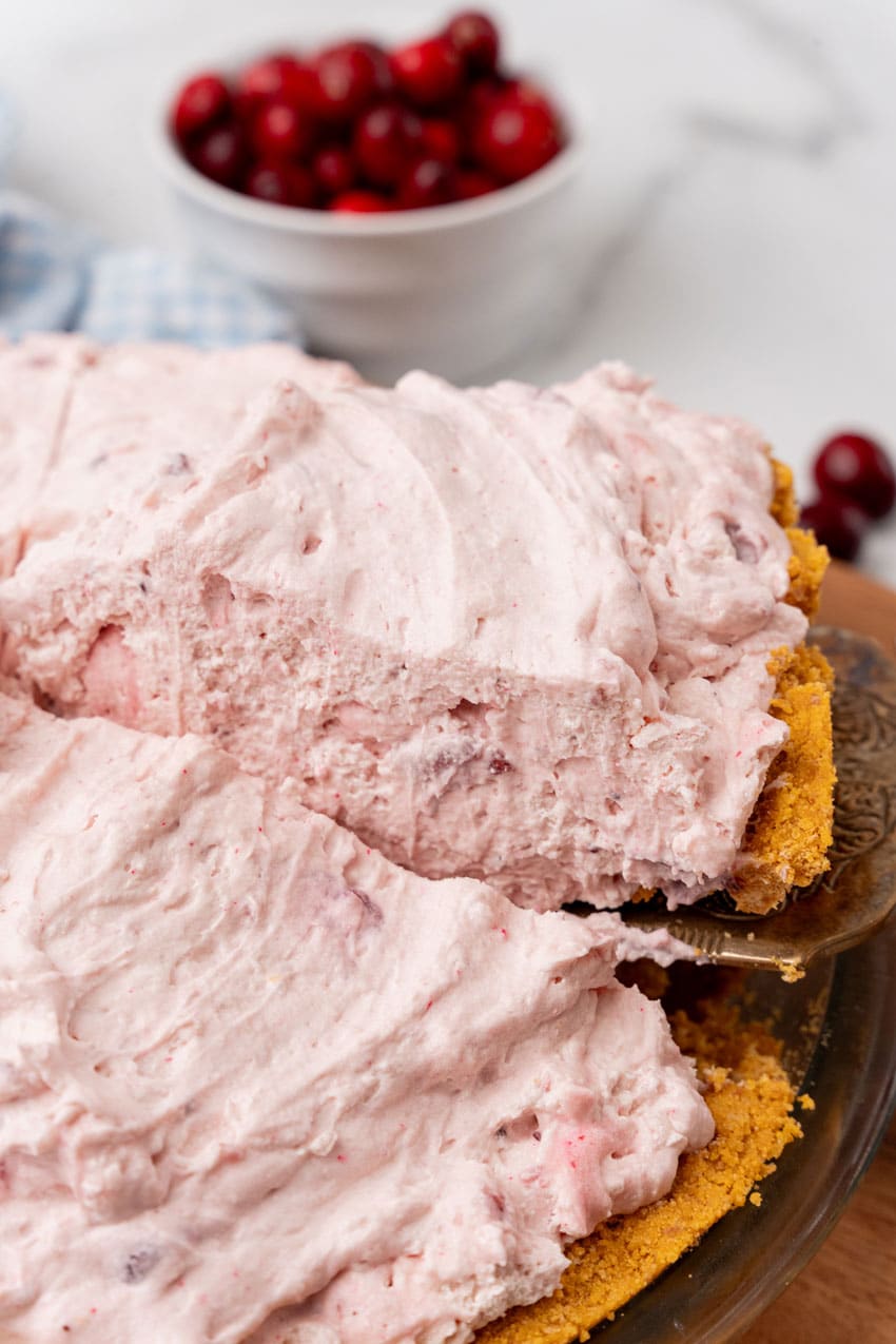 a slice of cranberry fluff pie being lifted up by a spatula