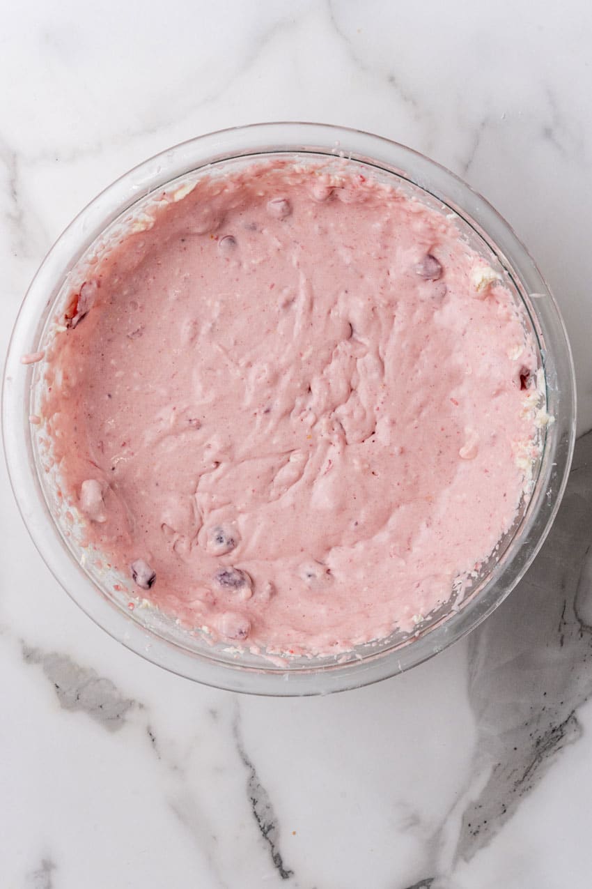 cranberry fluff pie filling in a glass mixing bowl