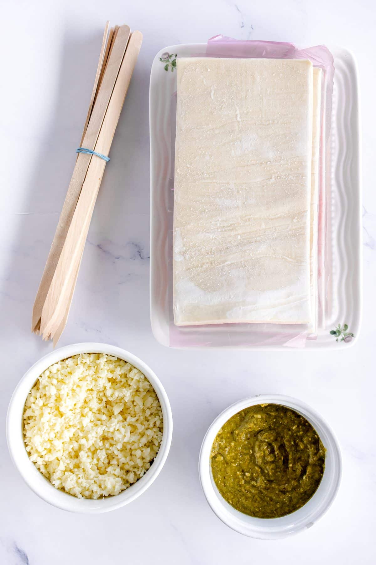 an overhead image showing the measured ingredients needed to make a batch of puff pastry christmas trees