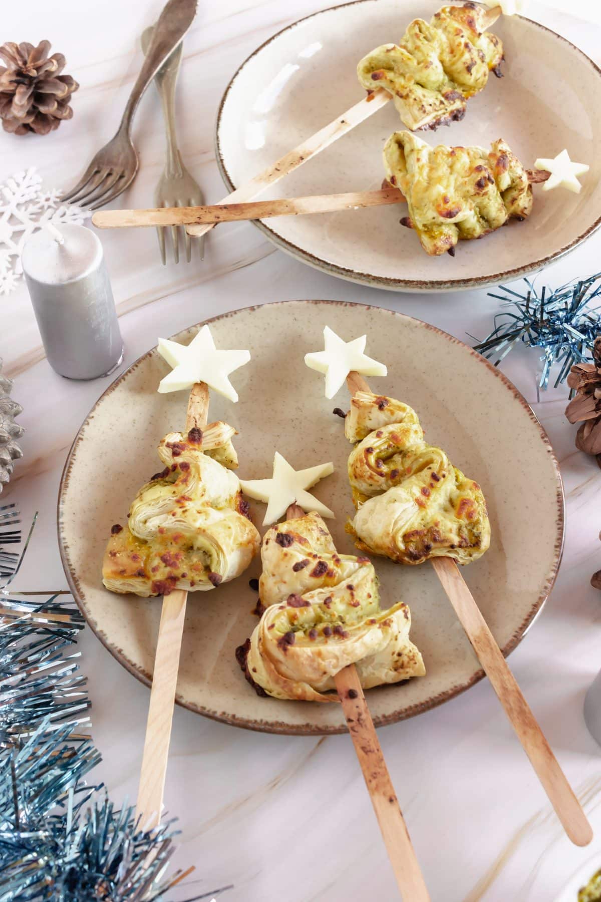 pesto puff pastry christmas trees on a white plate