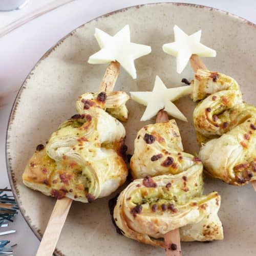 pesto puff pastry christmas trees on a white plate