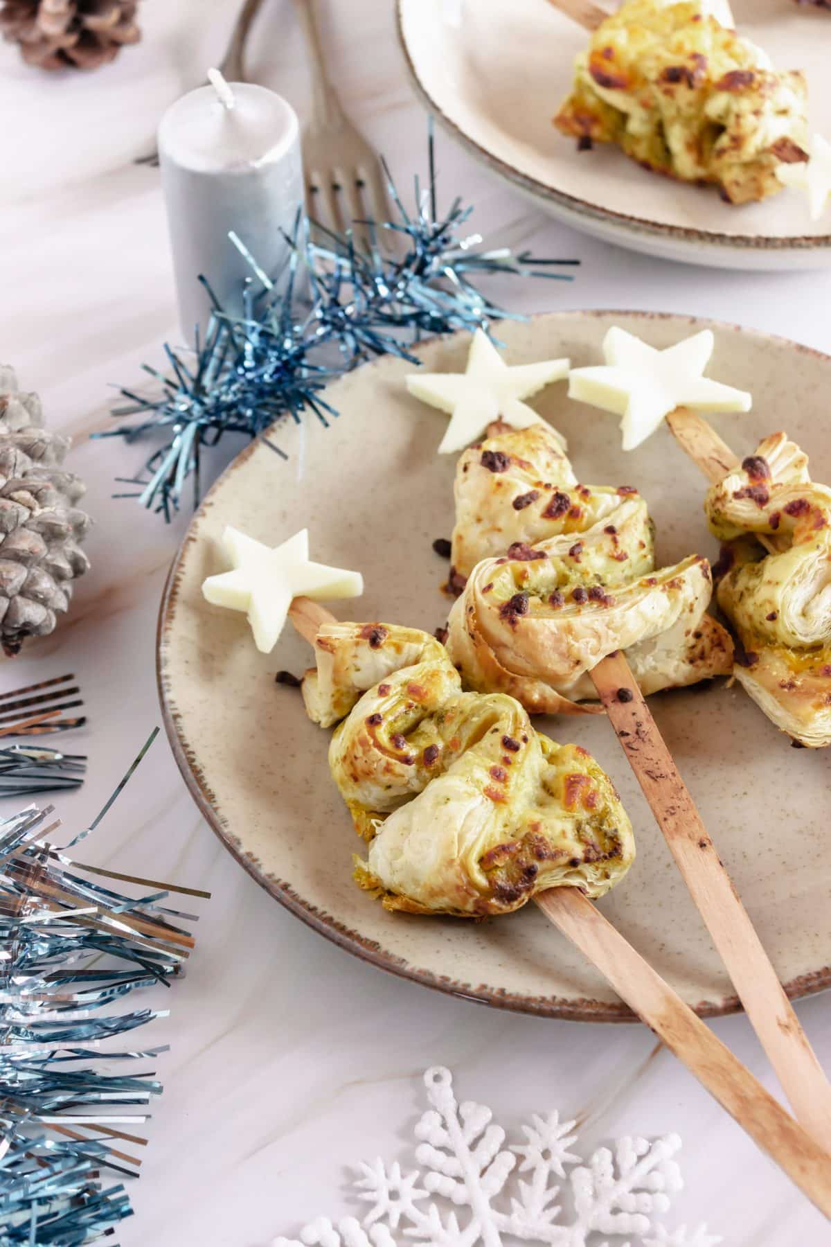 pesto puff pastry christmas trees on a white plate