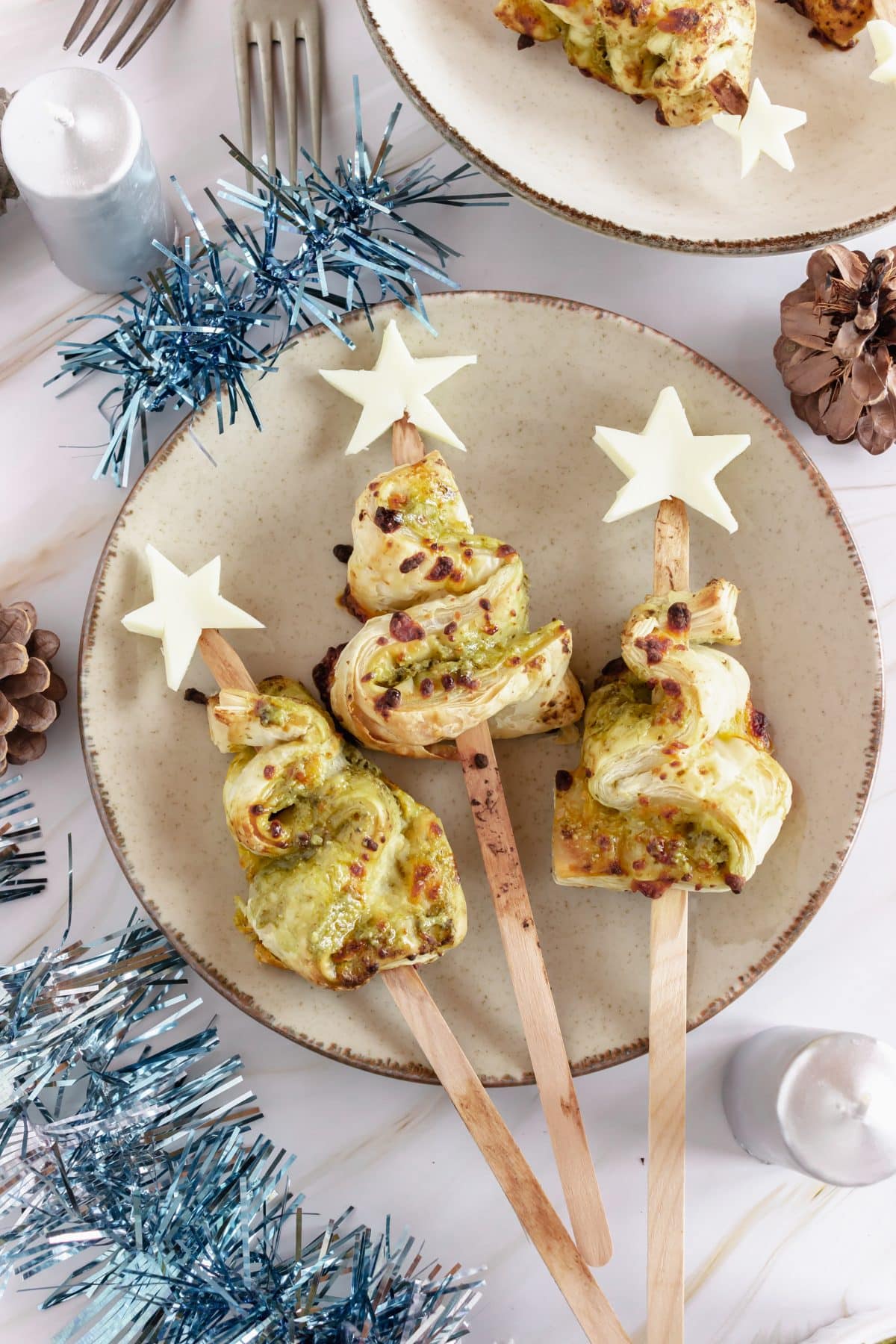pesto puff pastry christmas trees on a white plate
