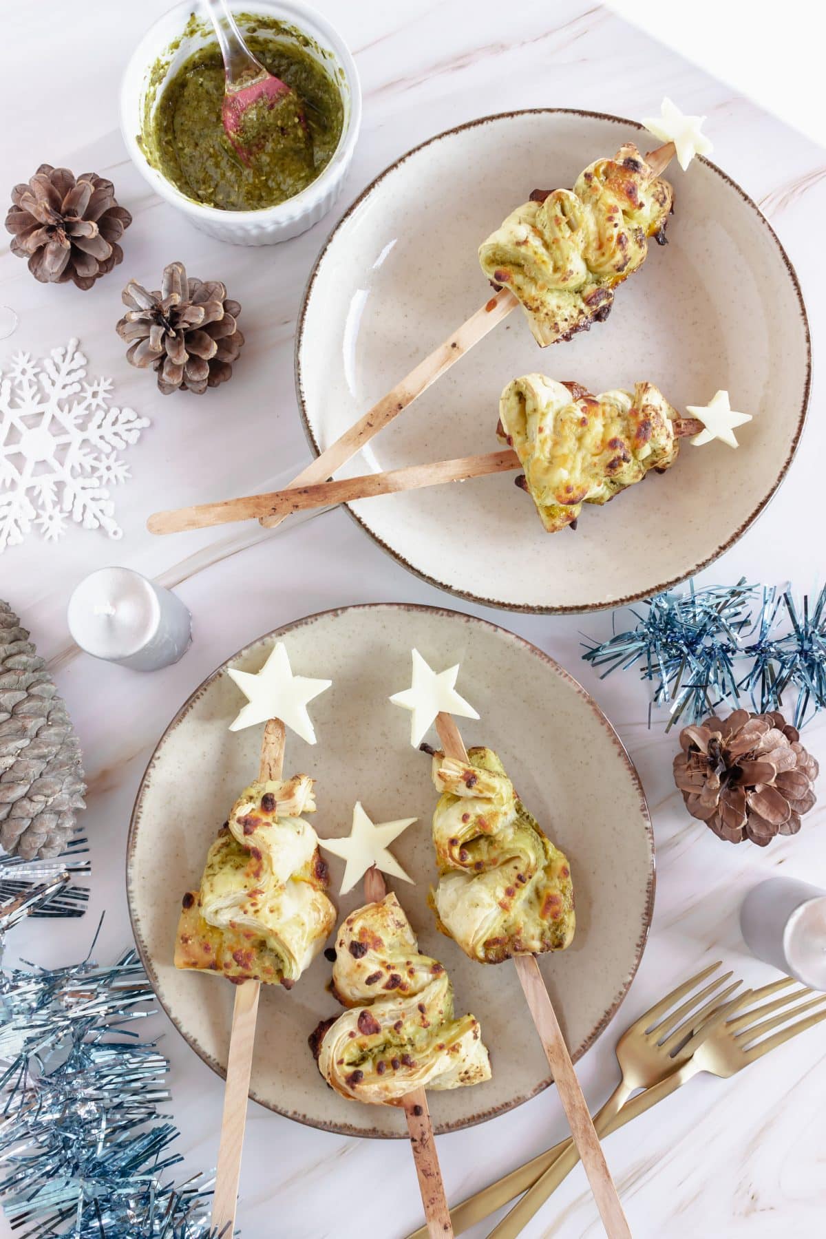 pesto puff pastry christmas trees on a white plate