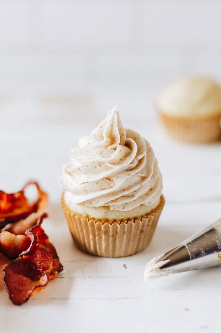 cinnamon frosting topped pancake muffin on a white tabletop
