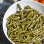 instant pot garlic green beans in a white serving bowl