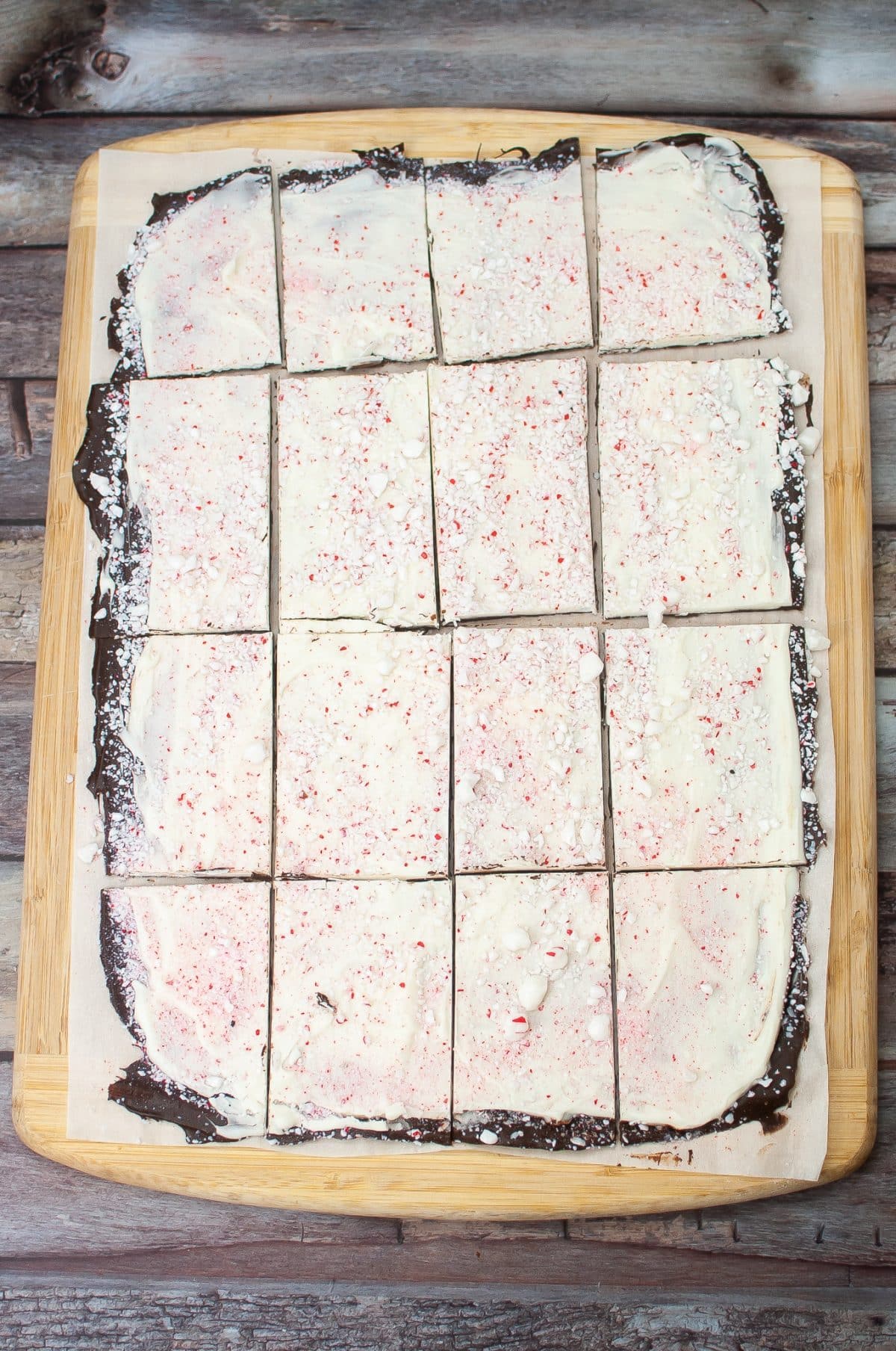 sliced peppermint bark on a wooden cutting board