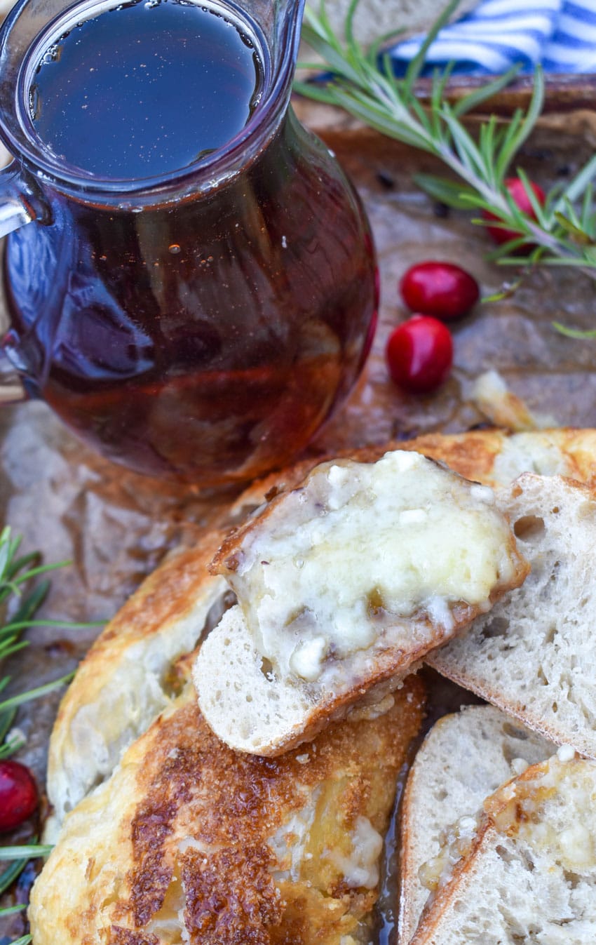 melted brie cheese spread on a slice of baguette bread
