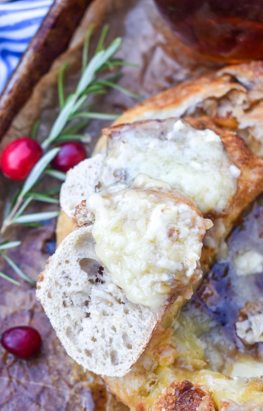 melted brie cheese spread on a slice of baguette bread