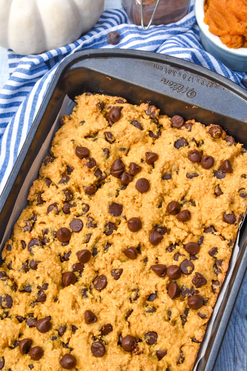 baked pumpkin chocolate chip cookie bars in a metal brownie pan