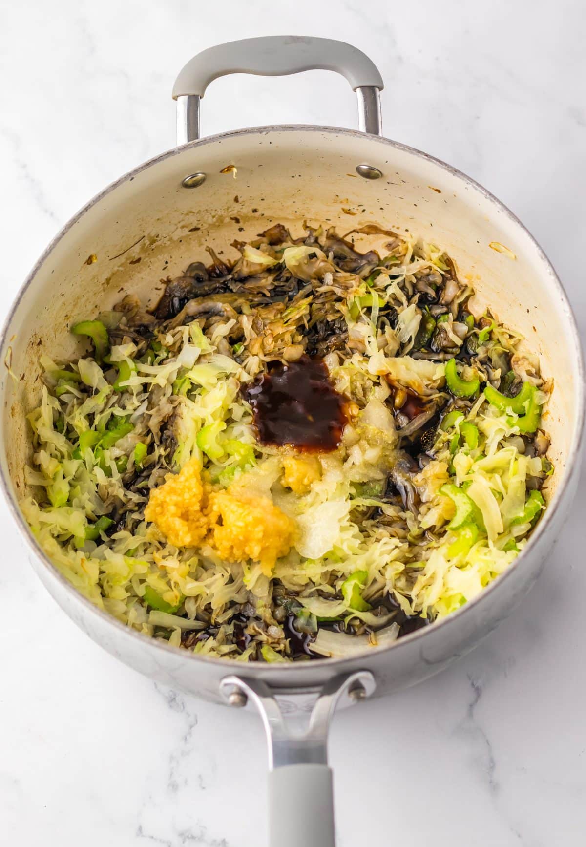 chow mein vegetables with sauce in a large gray pot