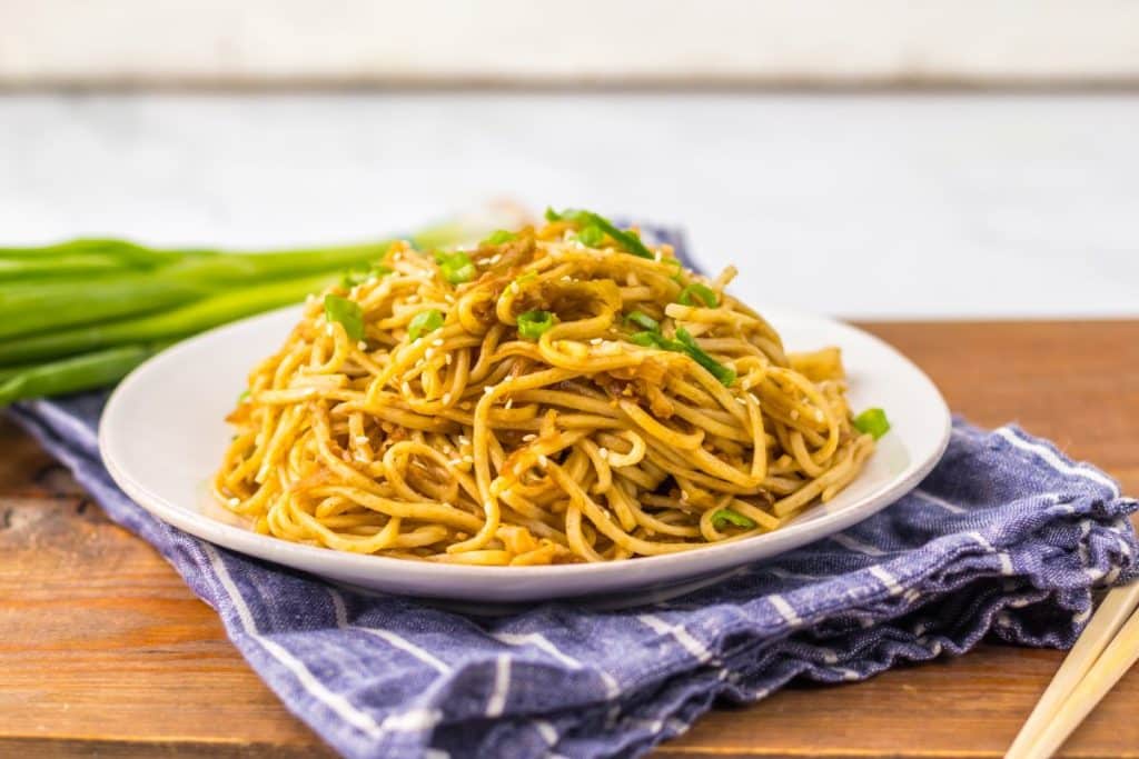 homemade chinese chow mein on a small white plate