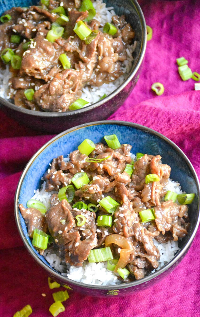 homemade beef bulgogi recipe served over steamed white rice in two small blue bowls