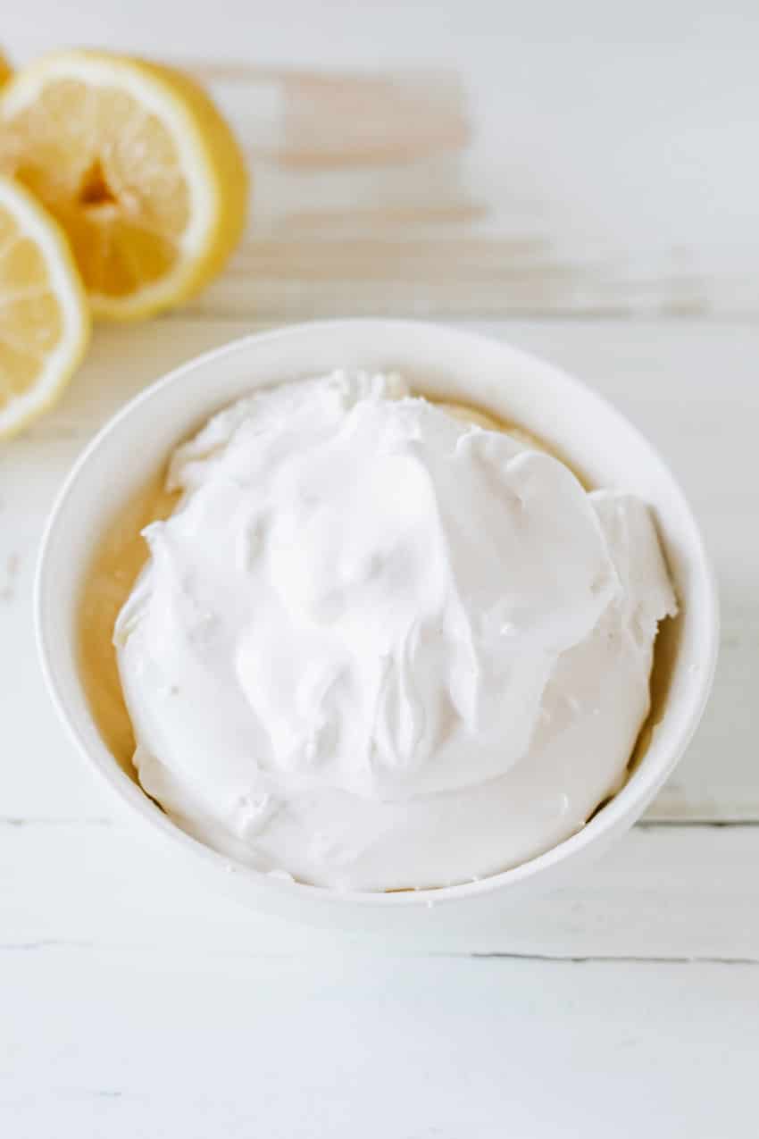 lemon pudding and whipped topping together in a small white bowl