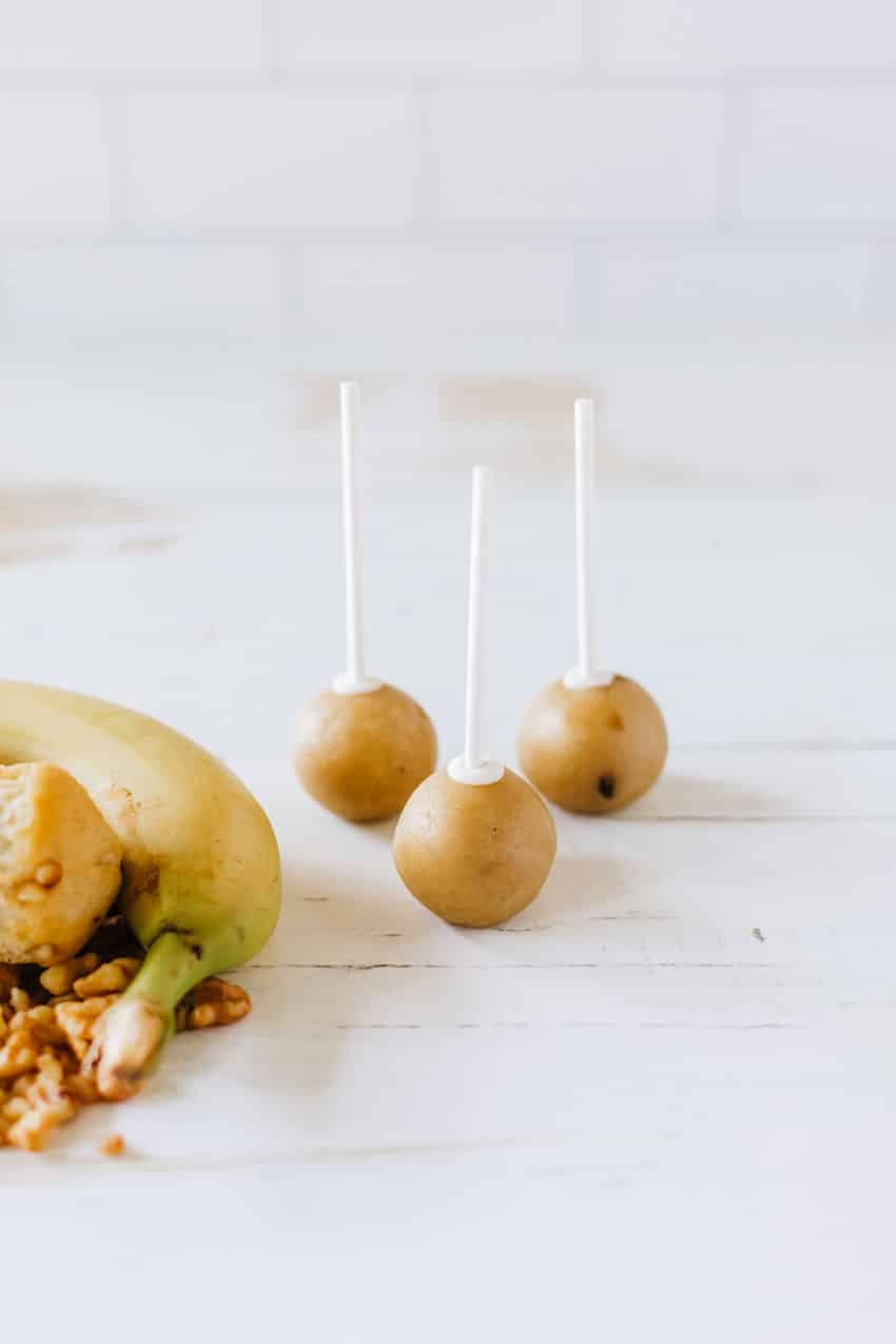 three naked banana bread cake pops on a wooden table