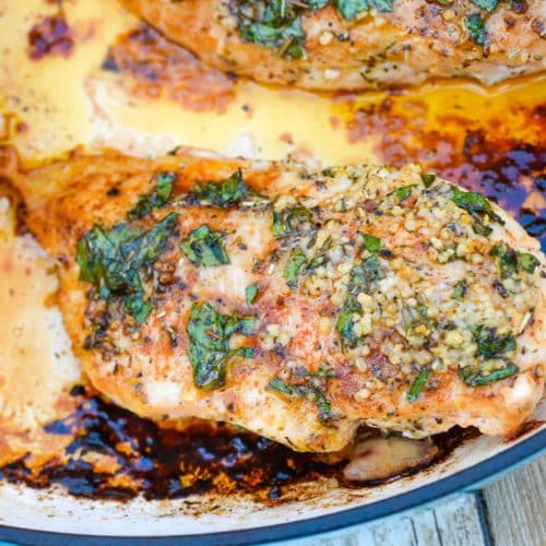 baked garlic butter chicken in a cast iron skillet