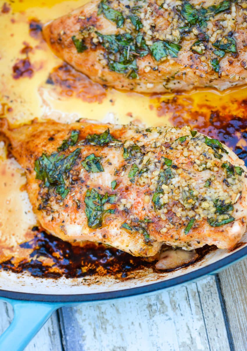 baked garlic butter chicken in a cast iron skillet