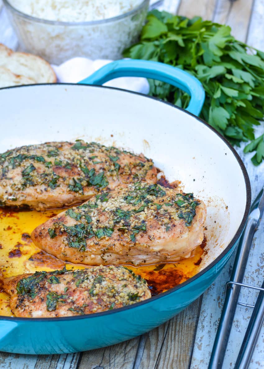 baked garlic butter chicken in a cast iron skillet