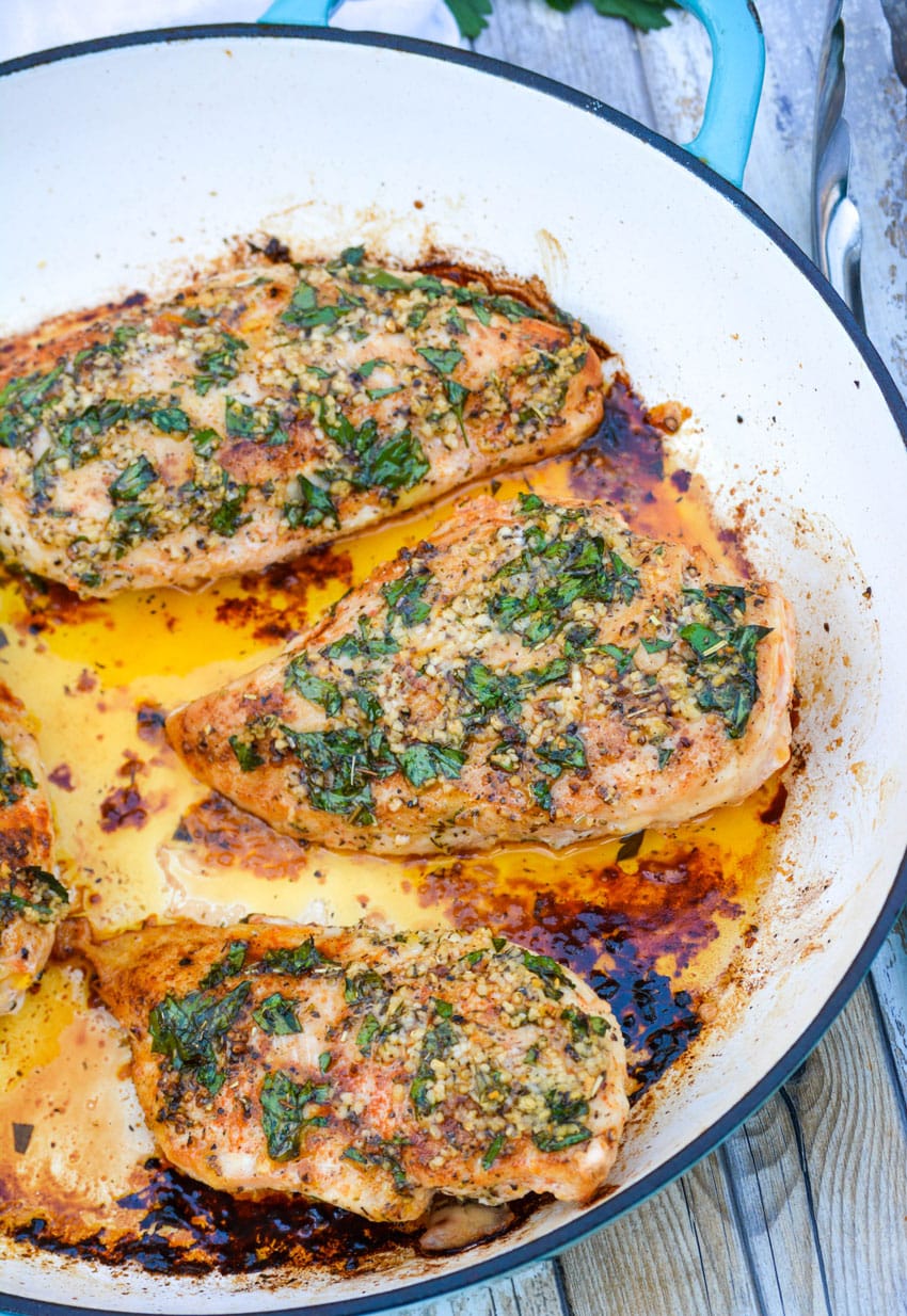 baked garlic butter chicken in a cast iron skillet
