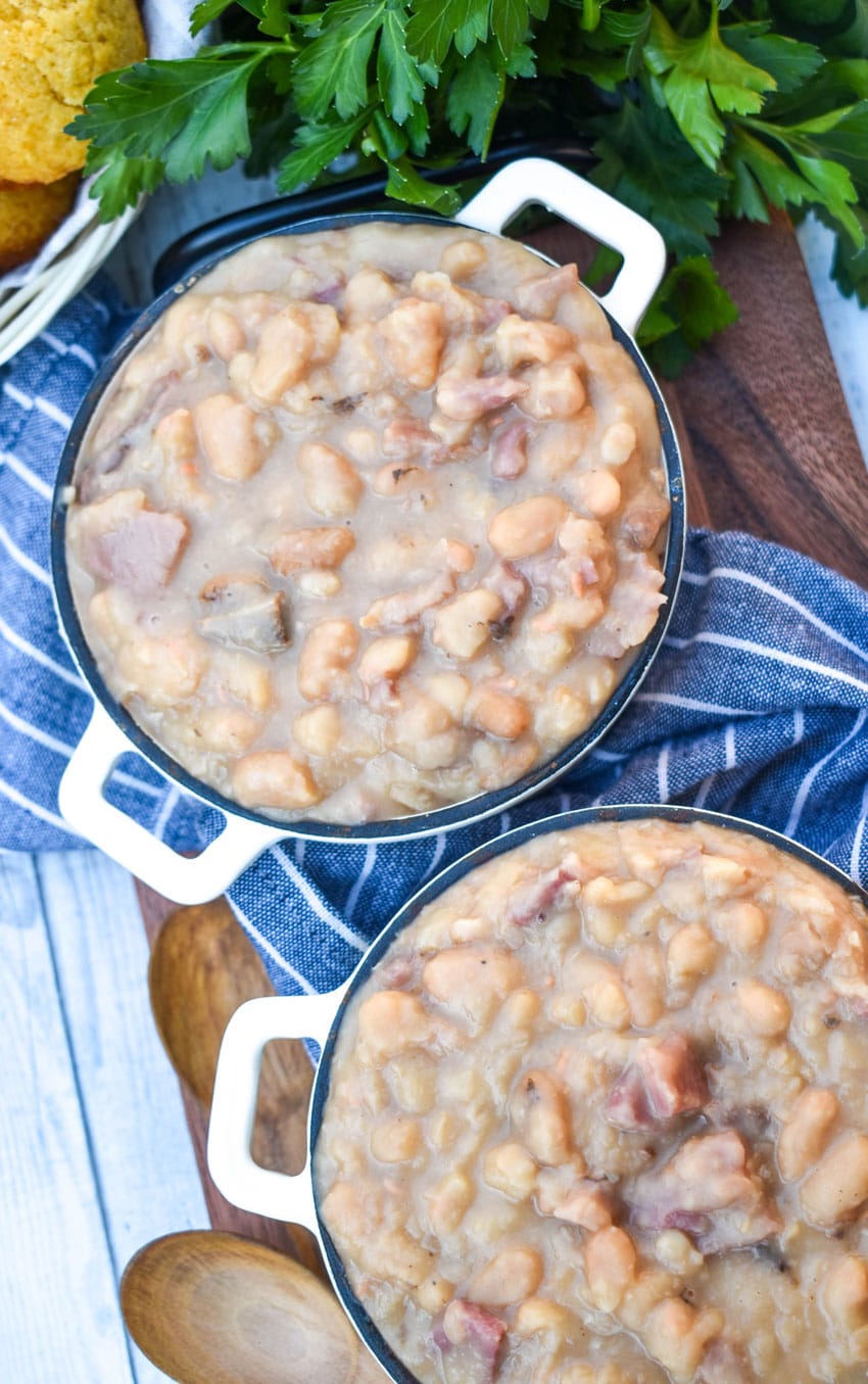 instant pot ham and beans in two small crocks on a wooden cutting board