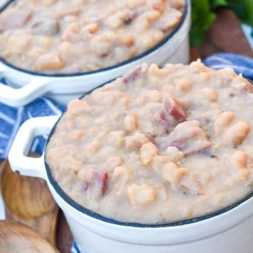 instant pot ham and beans in two small crocks on a wooden cutting board