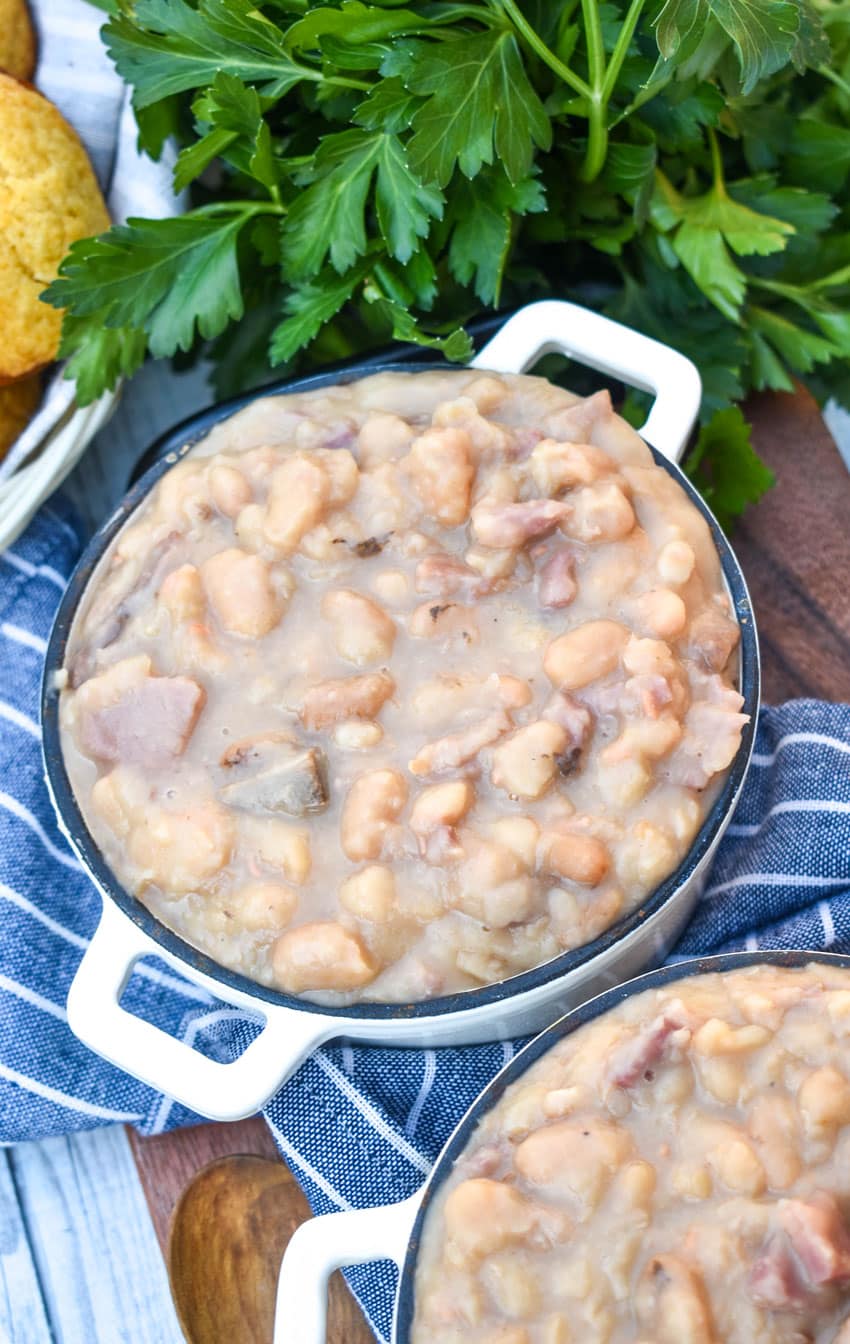 instant pot ham and beans in two small crocks on a wooden cutting board