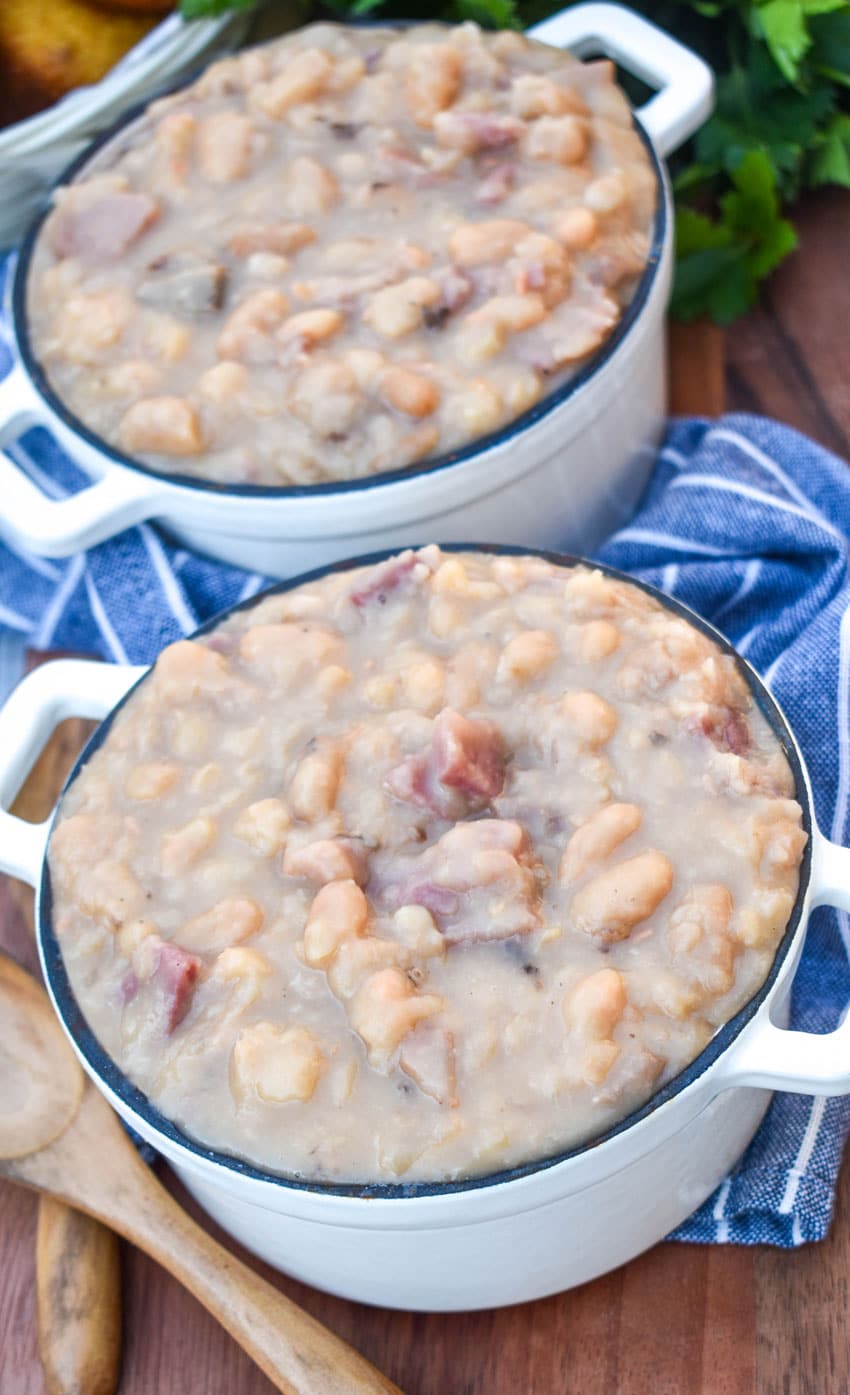 instant pot ham and beans in two small crocks on a wooden cutting board
