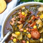 a silver spoon scooping swamp soup out of a white bowl