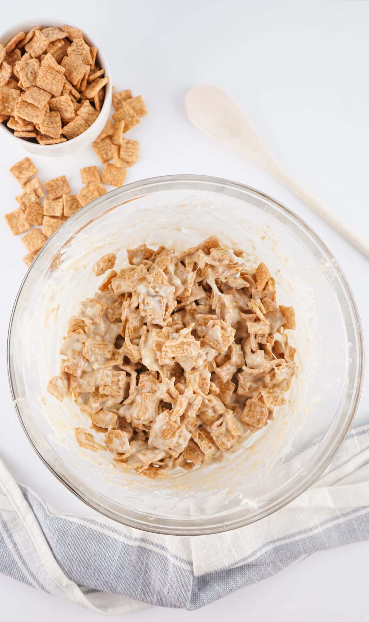marshmallow coated cinnamon toast crunch cereal in a glass mixing bowl