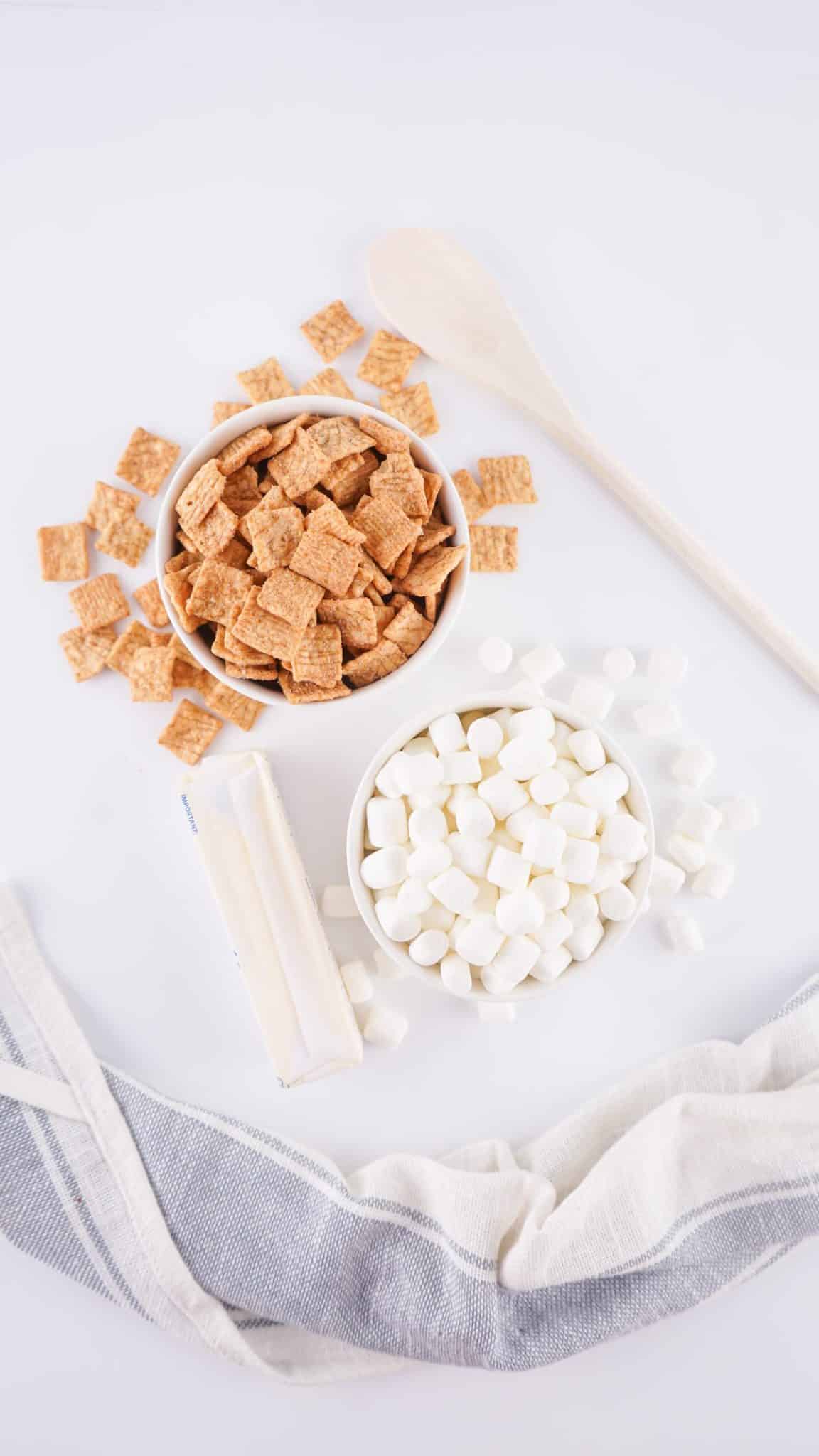 an overhead image showing the measured ingredients needed to make a batch of cinnamon toast crunch treats