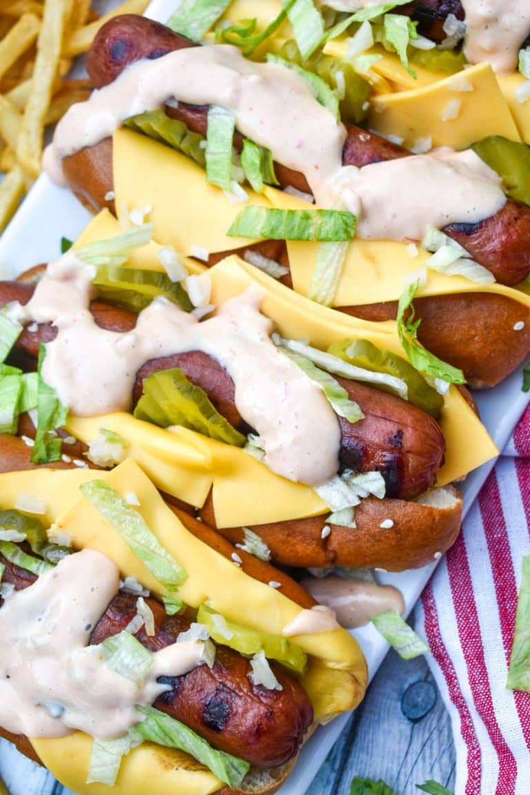 big mac hot dogs arranged in a row on a white serving platter