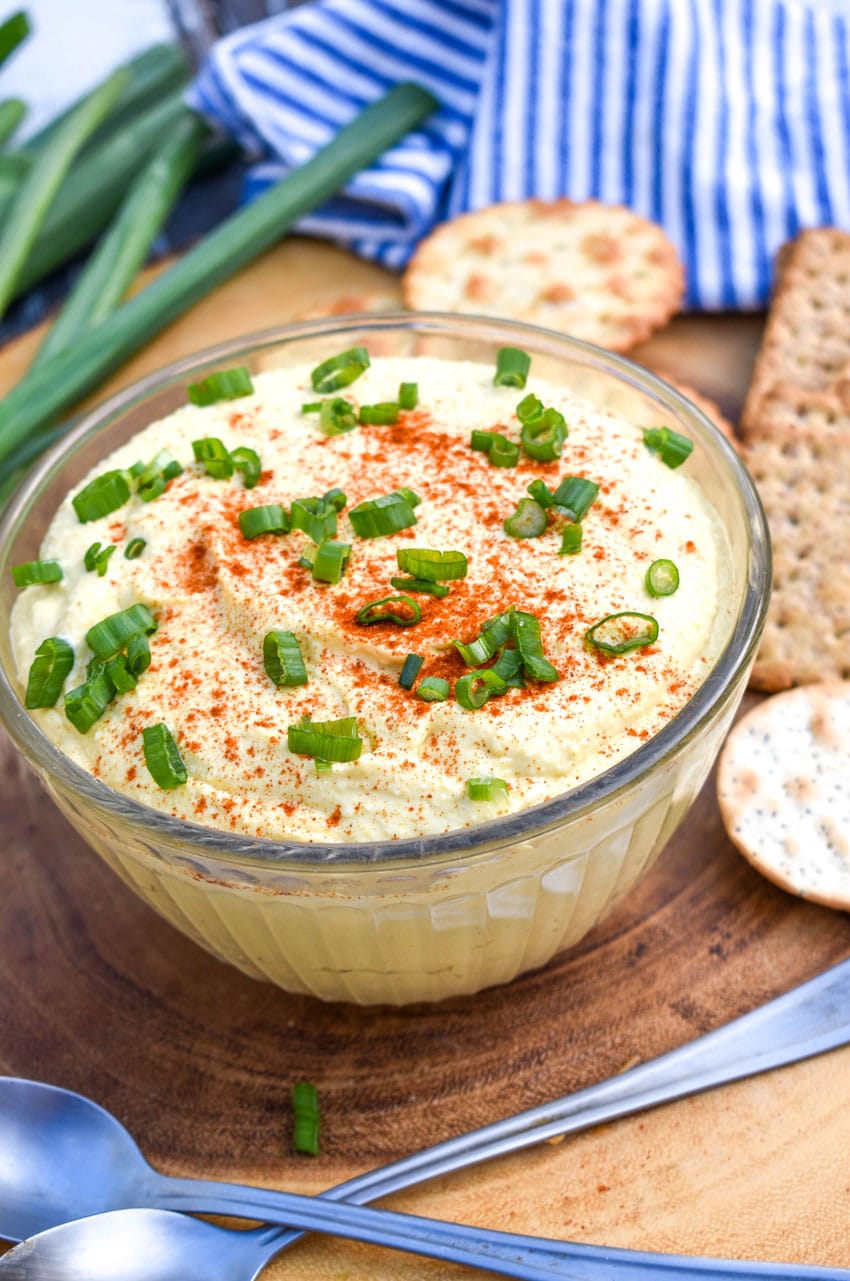 Deviled Egg Dip DEVILED EGG DIP TOPPED WITH SLICED GREEN ONIONS IN A SMALL GLASS BOWL